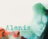 Alanis Morissette, visage en gros plan, évoquant le sentiment d'une "jagged little pill" à travers une esthétique visuelle audacieuse.