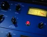 Gros plan sur un appareil audio bleu, avec des boutons et un VU-mètre. Idéal pour l'enregistrement voix.