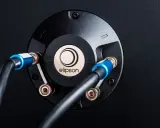 Connexion de câbles audio sur un bornier Elipson. Le montage fiche banane assure une connexion stable pour un son optimal.