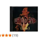 Pochette d'album live de Willy DeVille, avec le chanteur au micro. Un classique pour les amateurs de ses chansons.