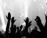 Foule en délire, mains levées vers la scène. Une image forte pour le marketing musical, capturant l'énergie d'un concert.