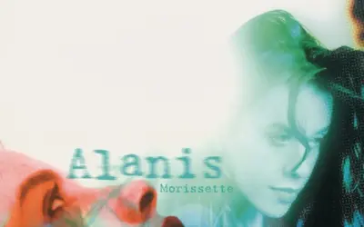 Alanis Morissette, visage en gros plan, évoquant le sentiment d'une "jagged little pill" à travers une esthétique visuelle audacieuse.