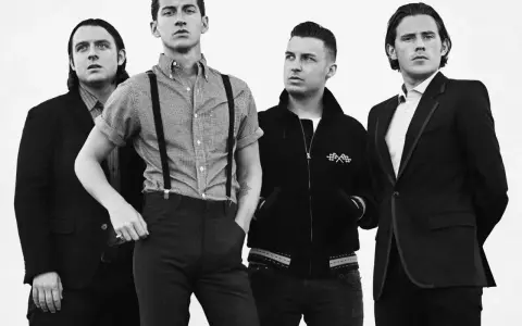Les membres d'Arctic Monkeys posent pour une photo d'album. Le groupe est en noir et blanc, avec des styles variés.