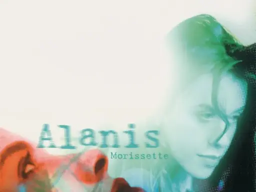 Alanis Morissette, visage en gros plan, évoquant le sentiment d'une "jagged little pill" à travers une esthétique visuelle audacieuse.