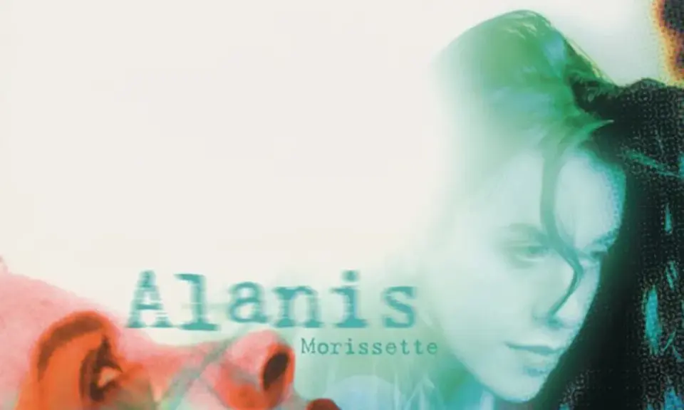 Alanis Morissette, visage en gros plan, évoquant le sentiment d'une "jagged little pill" à travers une esthétique visuelle audacieuse.